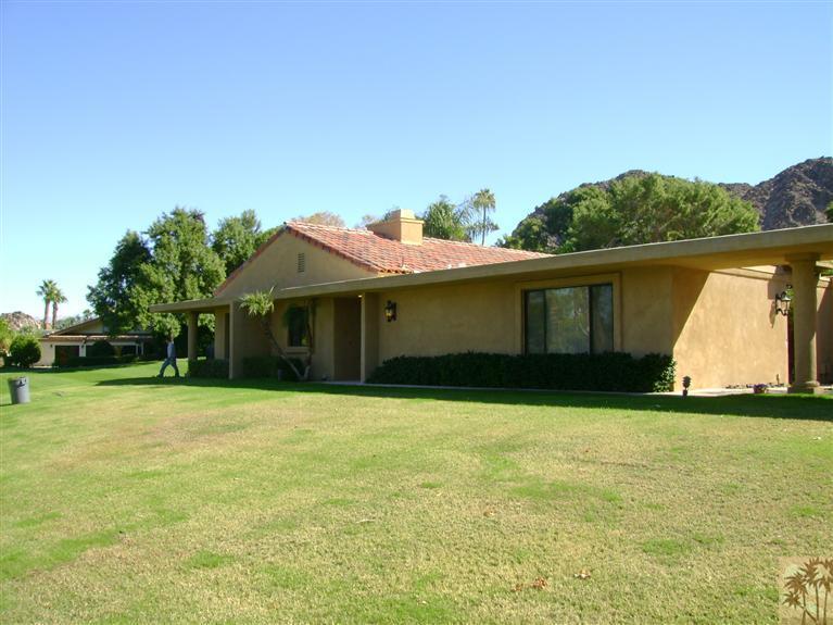 77950 Cherokee Road Indian Wells, CA 92210 - Photo 5 of 22 a front view of a house with a garden