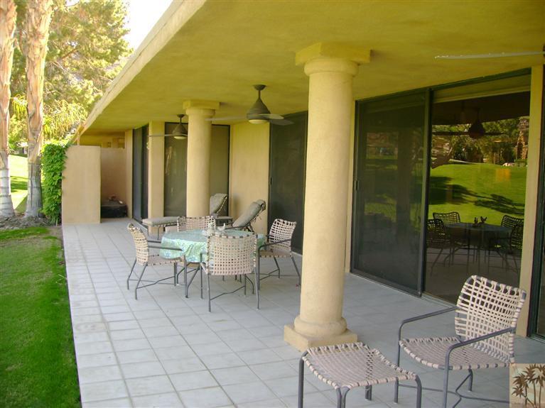 77950 Cherokee Road Indian Wells, CA 92210 - Photo 6 of 22 a view of a patio with table and chairs and potted plants