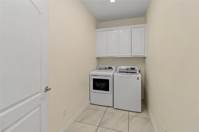 a view of a storage and utility room with washer and dryer