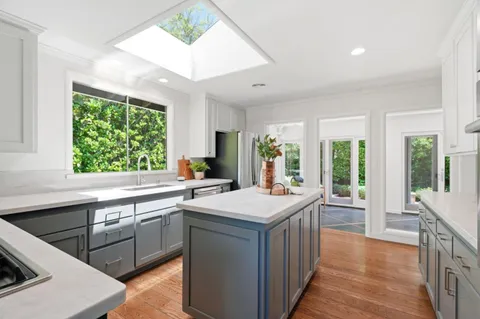 a kitchen with a sink stove and cabinets