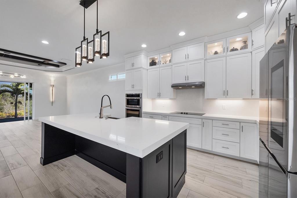 8920 Conch Avenue Placida, FL 33946 - Photo 11 of 57 a kitchen with kitchen island a sink stainless steel appliances and cabinets