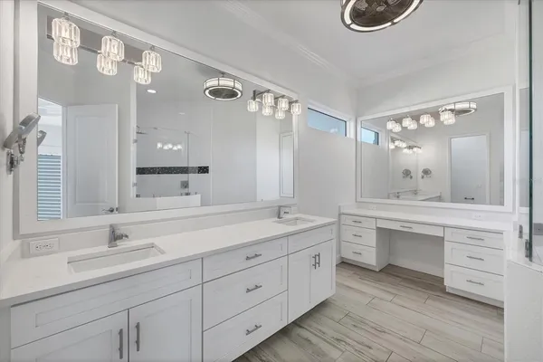 a bathroom with a sink a mirror and a shower