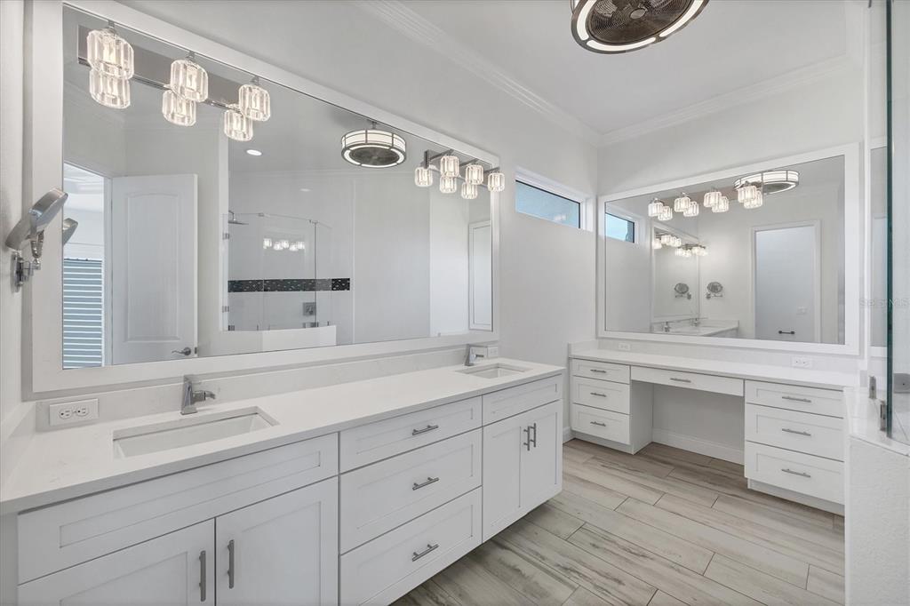 8920 Conch Avenue Placida, FL 33946 - Photo 20 of 57 a spacious bathroom with a double vanity sink and a mirror