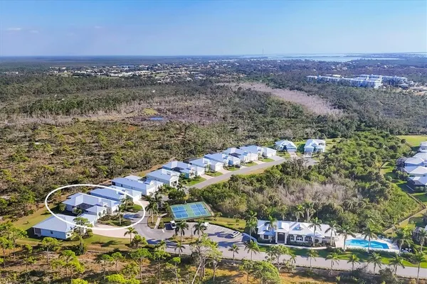 an aerial view of multiple houses with a yard