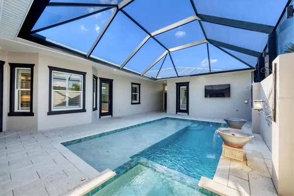 a view of a patio with couches table and chairs under an umbrella
