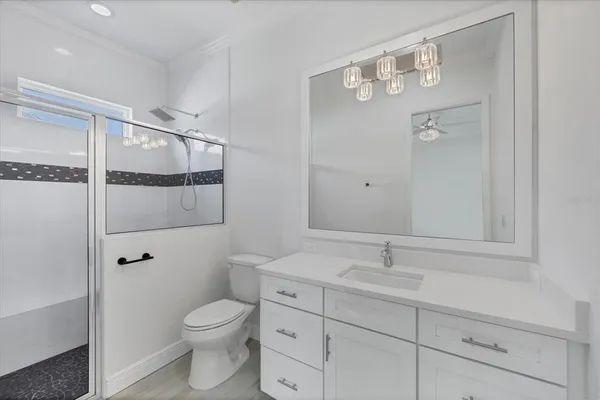 a kitchen with stainless steel appliances granite countertop a sink stove and refrigerator with wooden floor