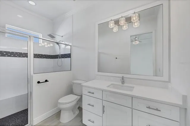 a kitchen with stainless steel appliances granite countertop a sink stove and refrigerator with wooden floor