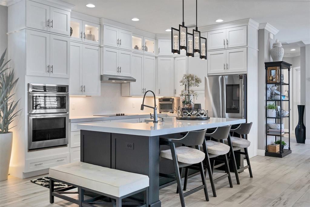 8920 Conch Avenue Placida, FL 33946 - Photo 38 of 57 a kitchen with stainless steel appliances granite countertop a sink stove and refrigerator with wooden floor