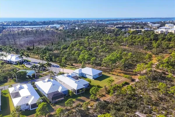 front view of house with a yard and potted plants