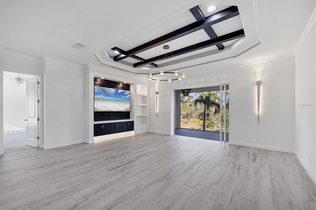 8920 Conch Avenue Placida, FL 33946 - Photo 6 of 57 an empty room with wooden floor cabinet and windows