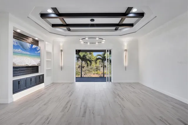 a room with stainless steel appliances kitchen island wooden floors and view living room