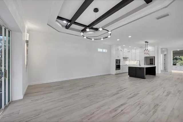a kitchen with kitchen island a sink stainless steel appliances and cabinets