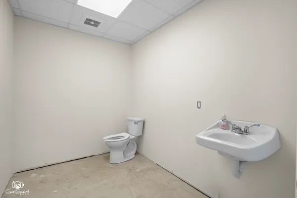 a bathroom with a sink toilet and a mirror