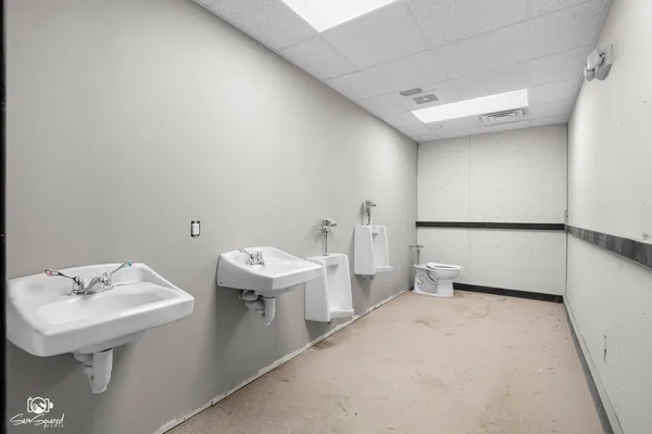 a bathroom with a sink a toilet and mirror