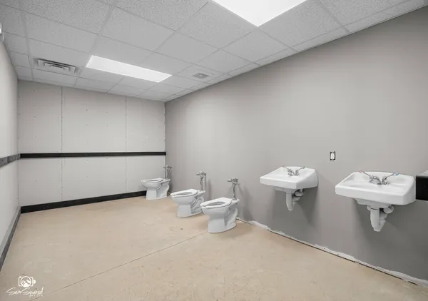 a bathroom with a sink a toilet and a mirror