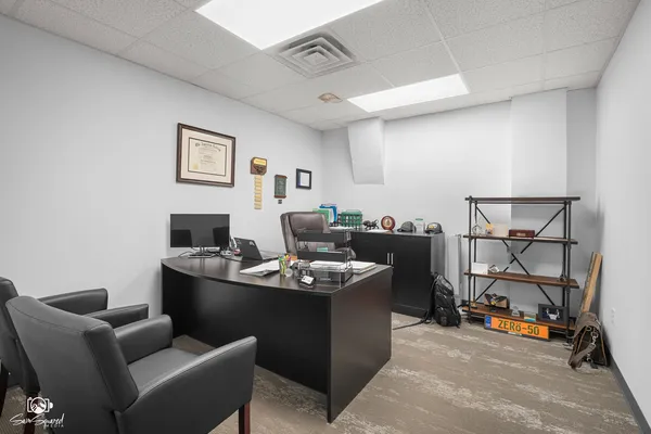 a living room with furniture a flat screen tv and a table