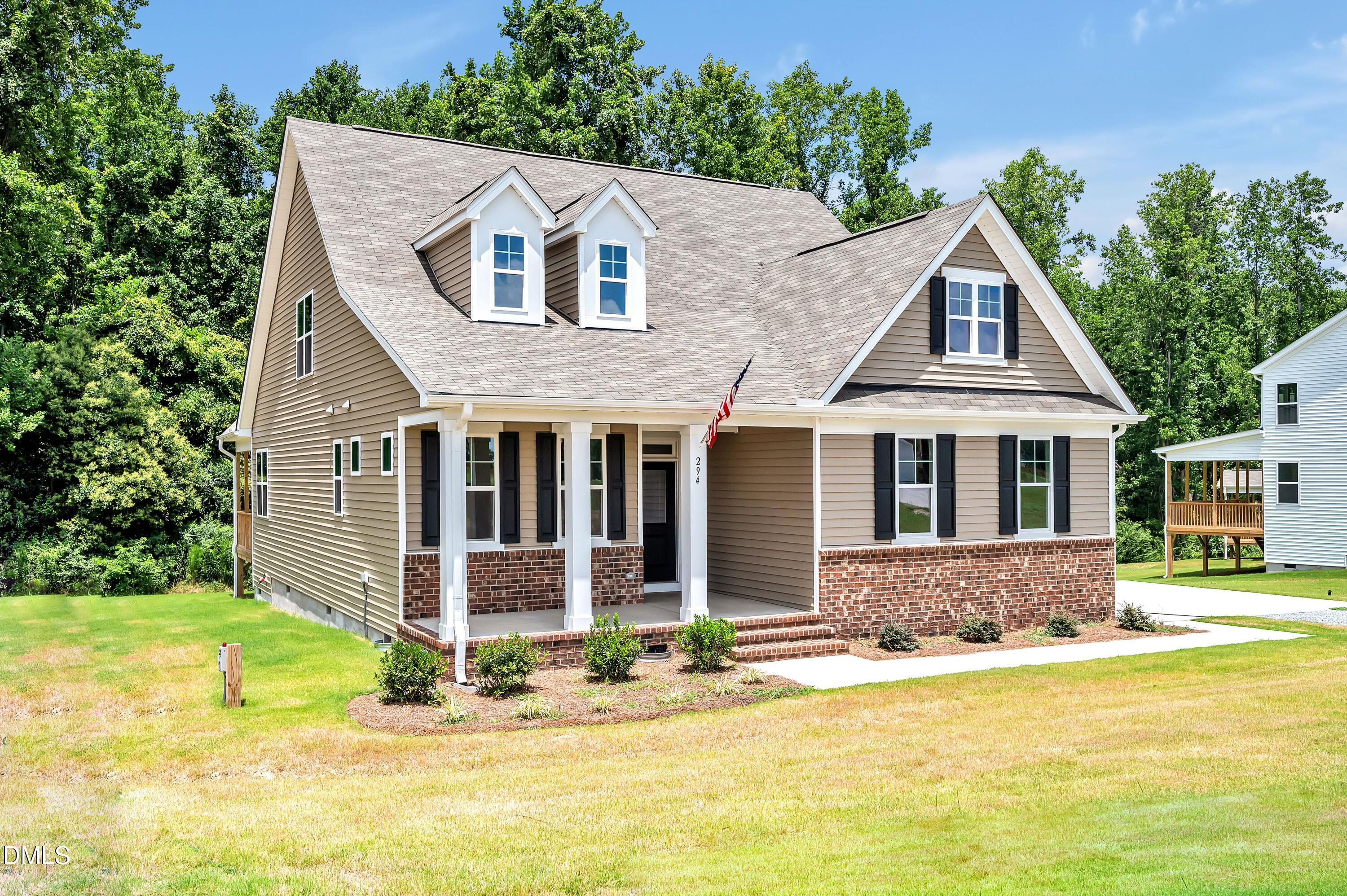 294 White Azalea Way Benson, NC 27504 - Photo 1 of 15 a front view of a house with a yard table and chairs