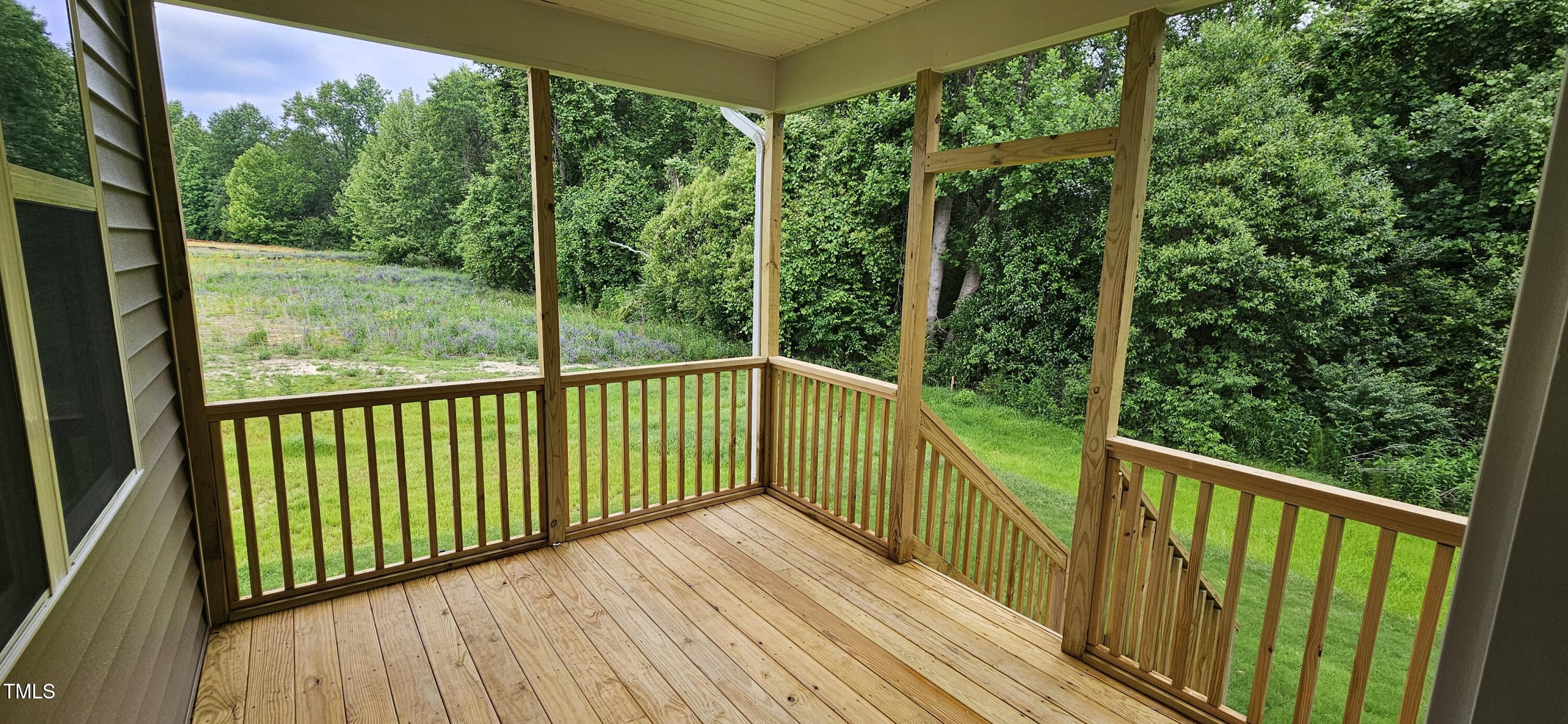 294 White Azalea Way Benson, NC 27504 - Photo 11 of 15 a view of a balcony with wooden floor