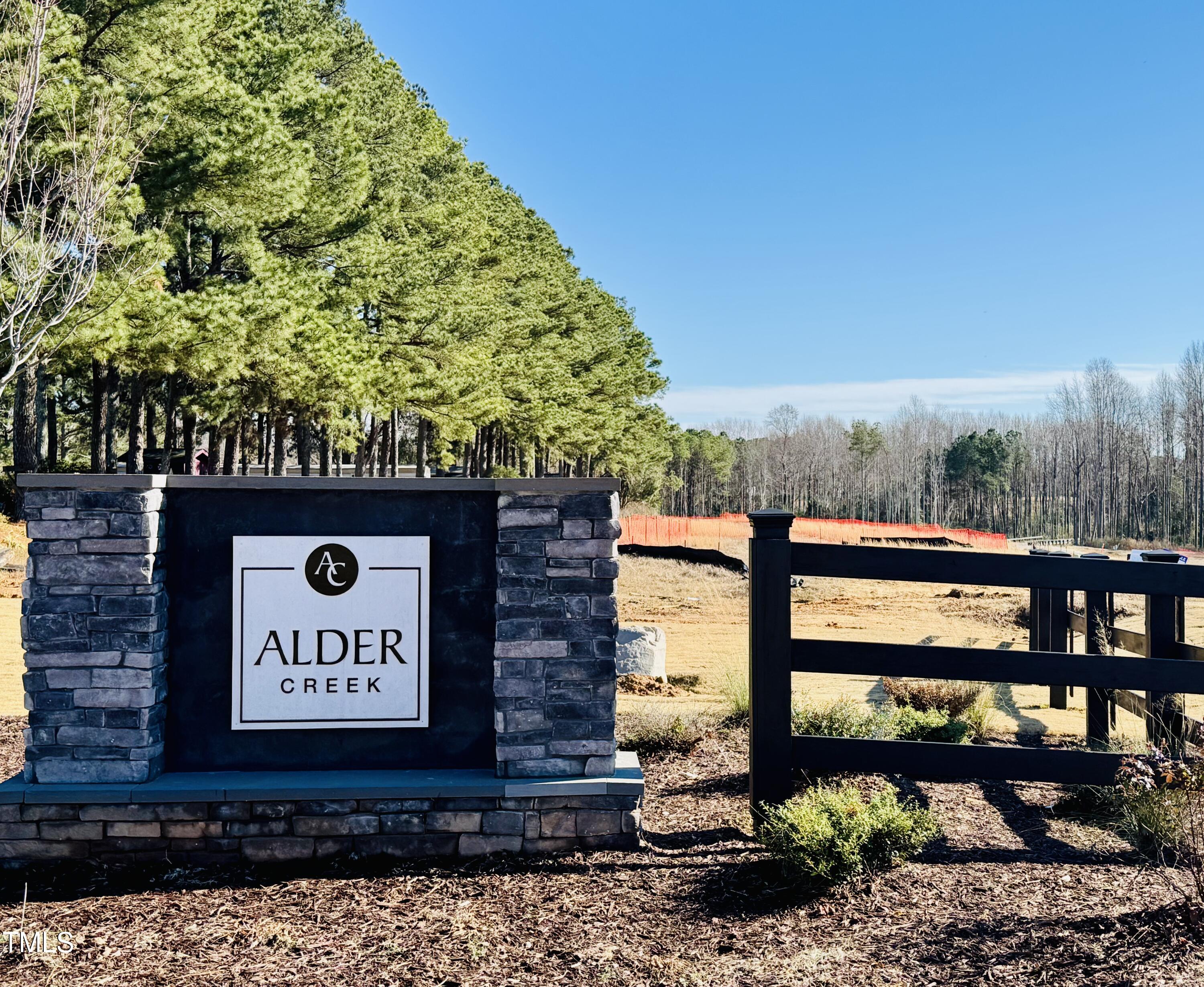 294 White Azalea Way Benson, NC 27504 - Photo 15 of 15 a sign that is sitting on a brick wall
