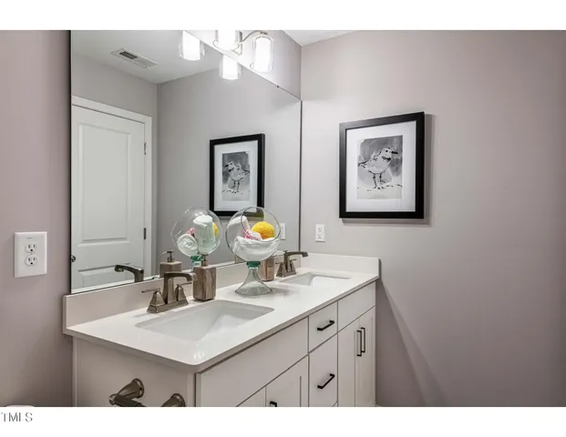 a view of a bathroom with a sink a mirror and a toilet