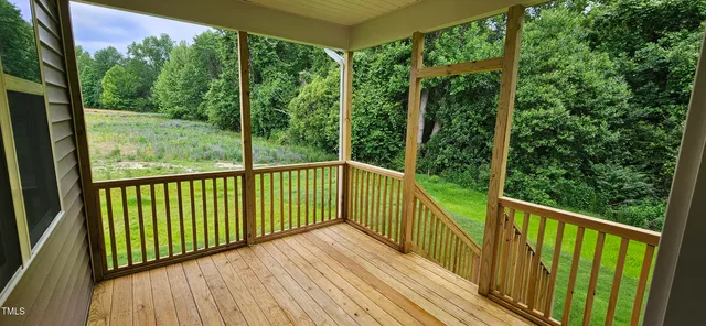 a view of a balcony with wooden floor