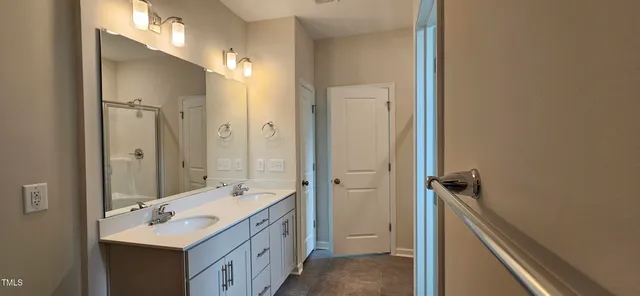 a bathroom with a sink a mirror and a shower