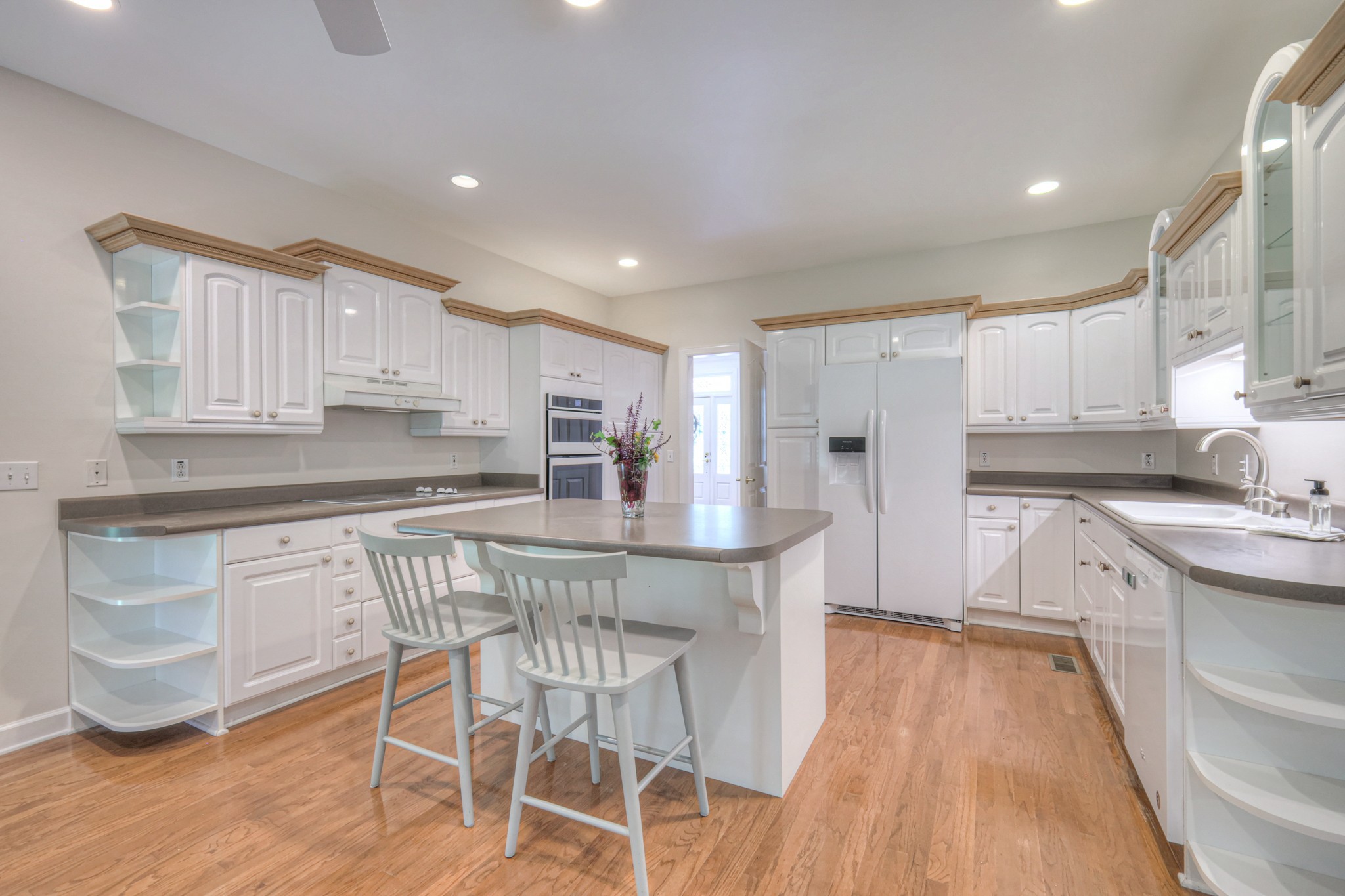 604 Georgian Way Mount Juliet, TN 37122 - Photo 26 of 58 a kitchen with stainless steel appliances granite countertop a white cabinets and wooden floor