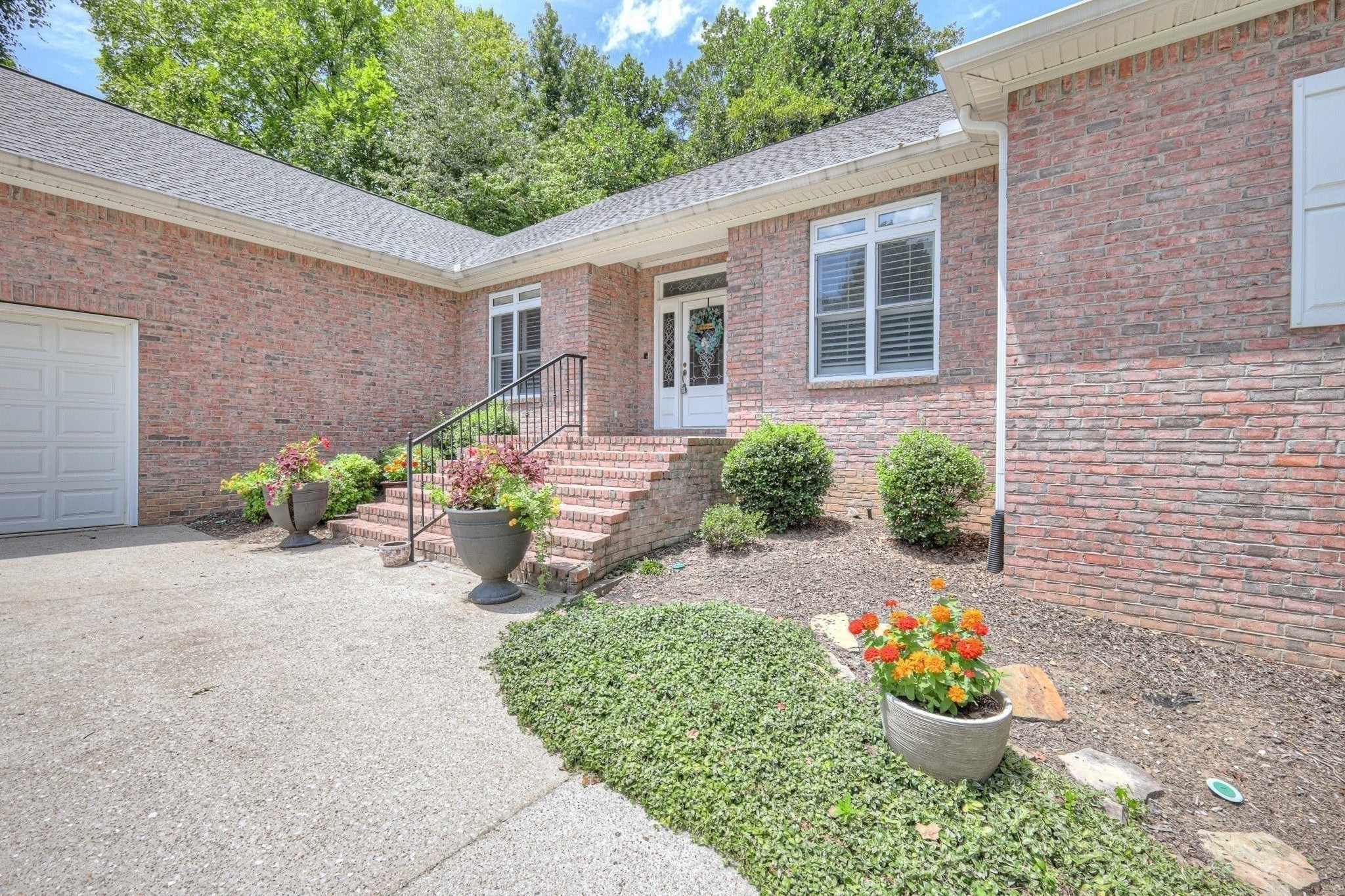 604 Georgian Way Mount Juliet, TN 37122 - Photo 3 of 58 a front view of a house with a yard and a garden