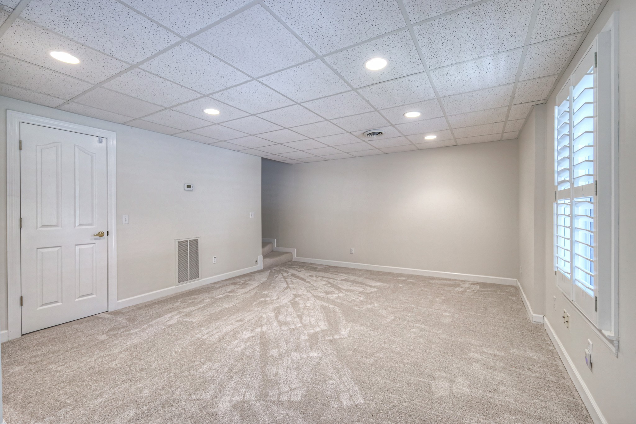 604 Georgian Way Mount Juliet, TN 37122 - Photo 45 of 58 an empty room with windows and chandelier fan