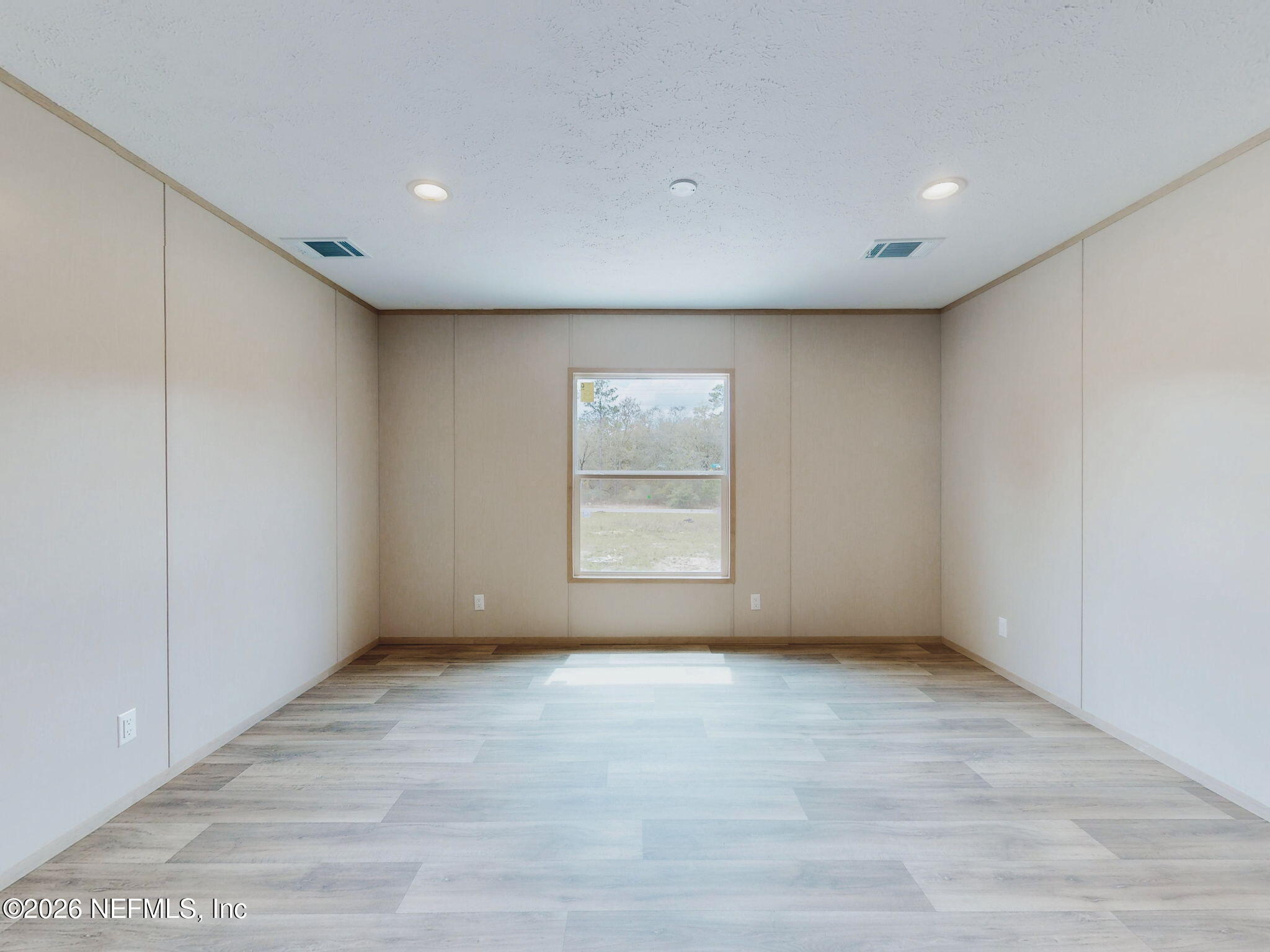 5784 County Road 214 Keystone Heights, FL 32656 - Photo 13 of 62 a view of an empty room with wooden floor and a window