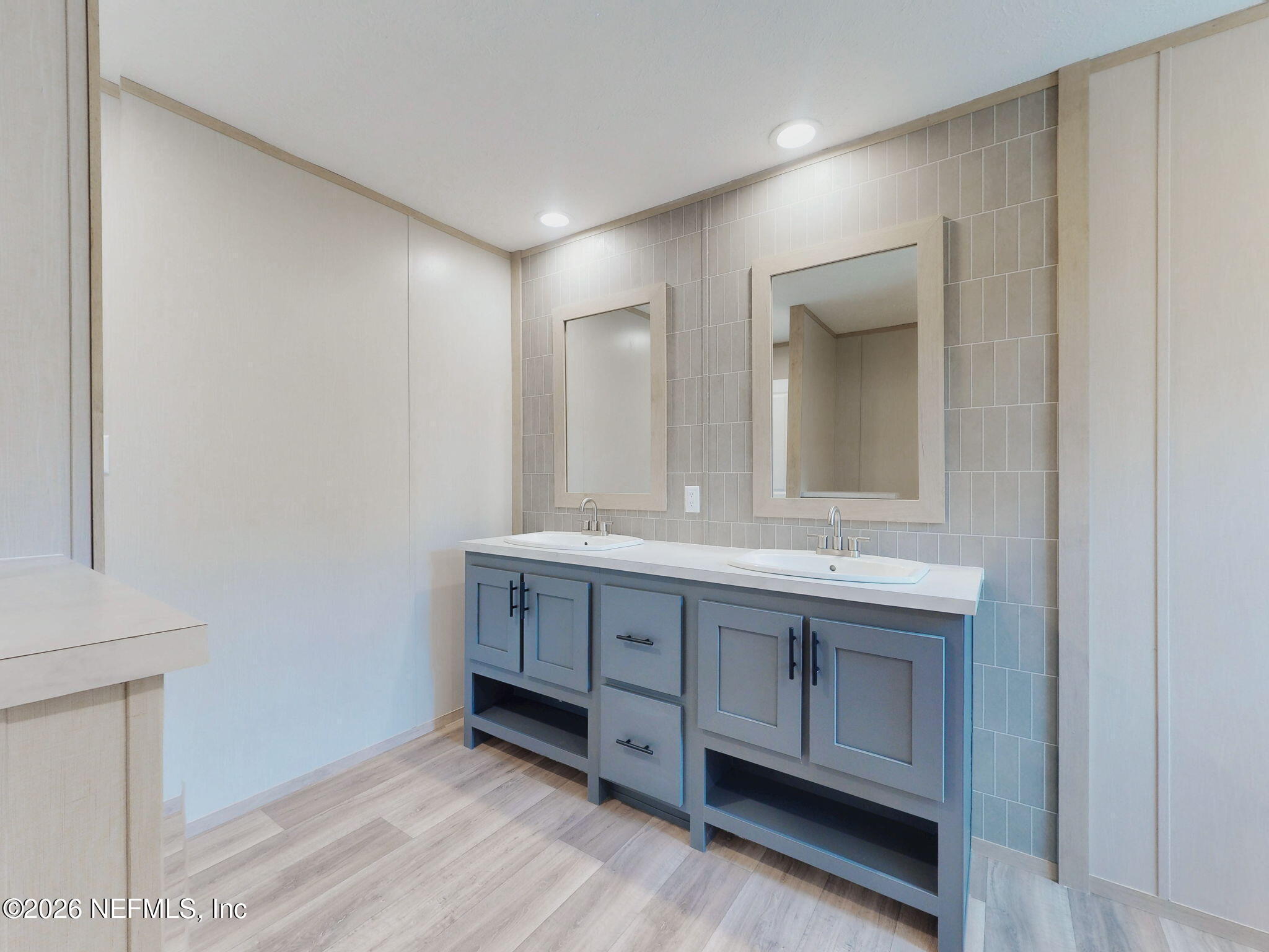 5784 County Road 214 Keystone Heights, FL 32656 - Photo 17 of 62 a bathroom with a double vanity sink and a mirror