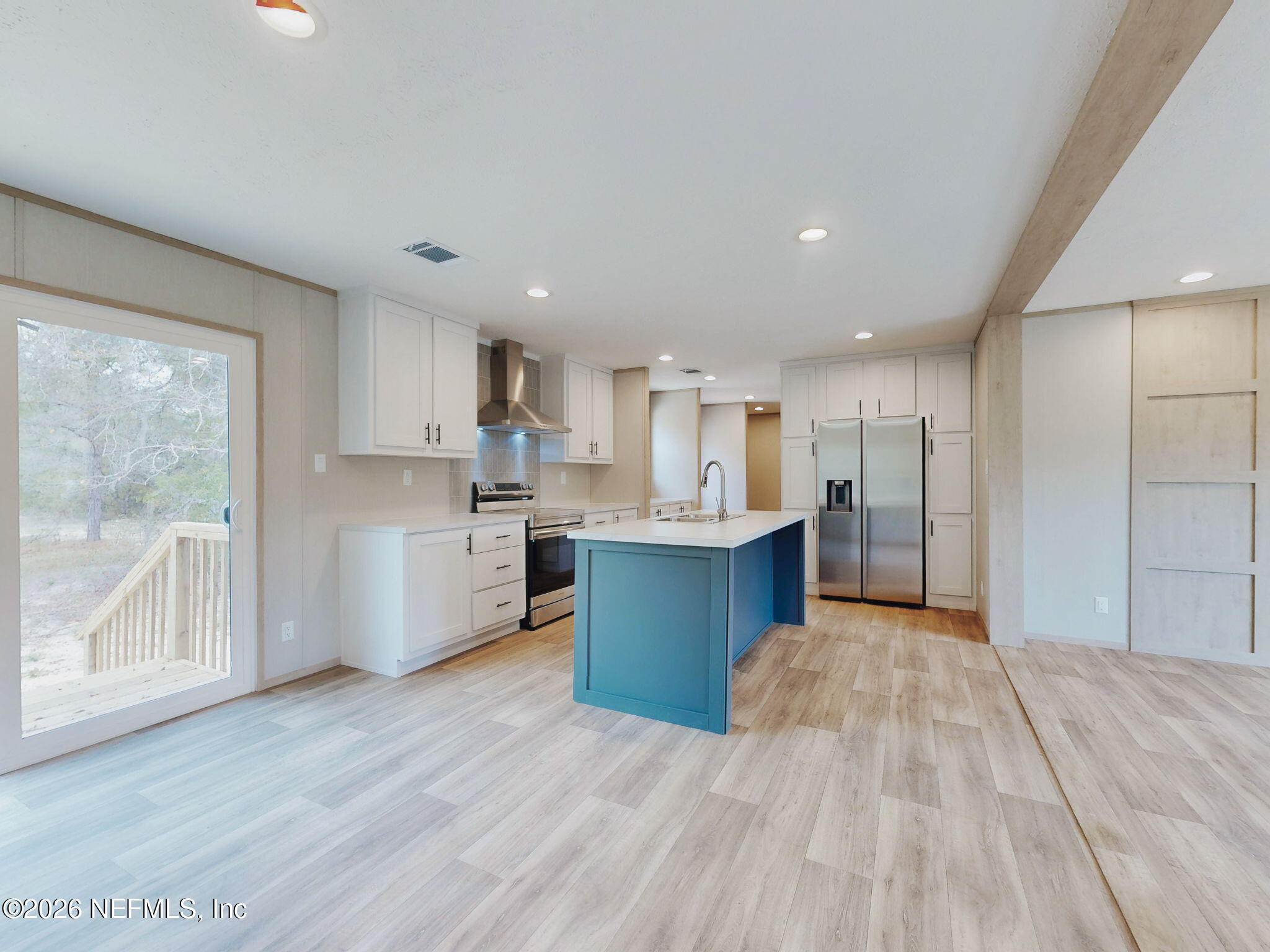 5784 County Road 214 Keystone Heights, FL 32656 - Photo 22 of 62 a large kitchen with a lot of counter space wooden cabinets and stainless steel appliances