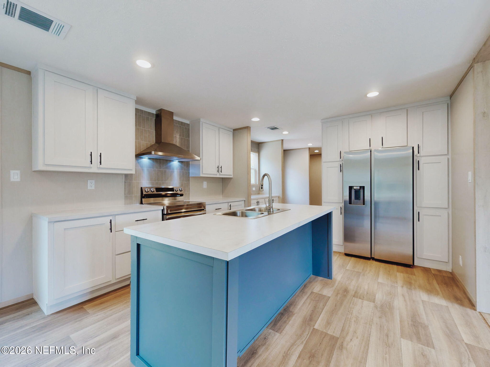 5784 County Road 214 Keystone Heights, FL 32656 - Photo 23 of 62 a kitchen with a sink stainless steel appliances and white cabinets