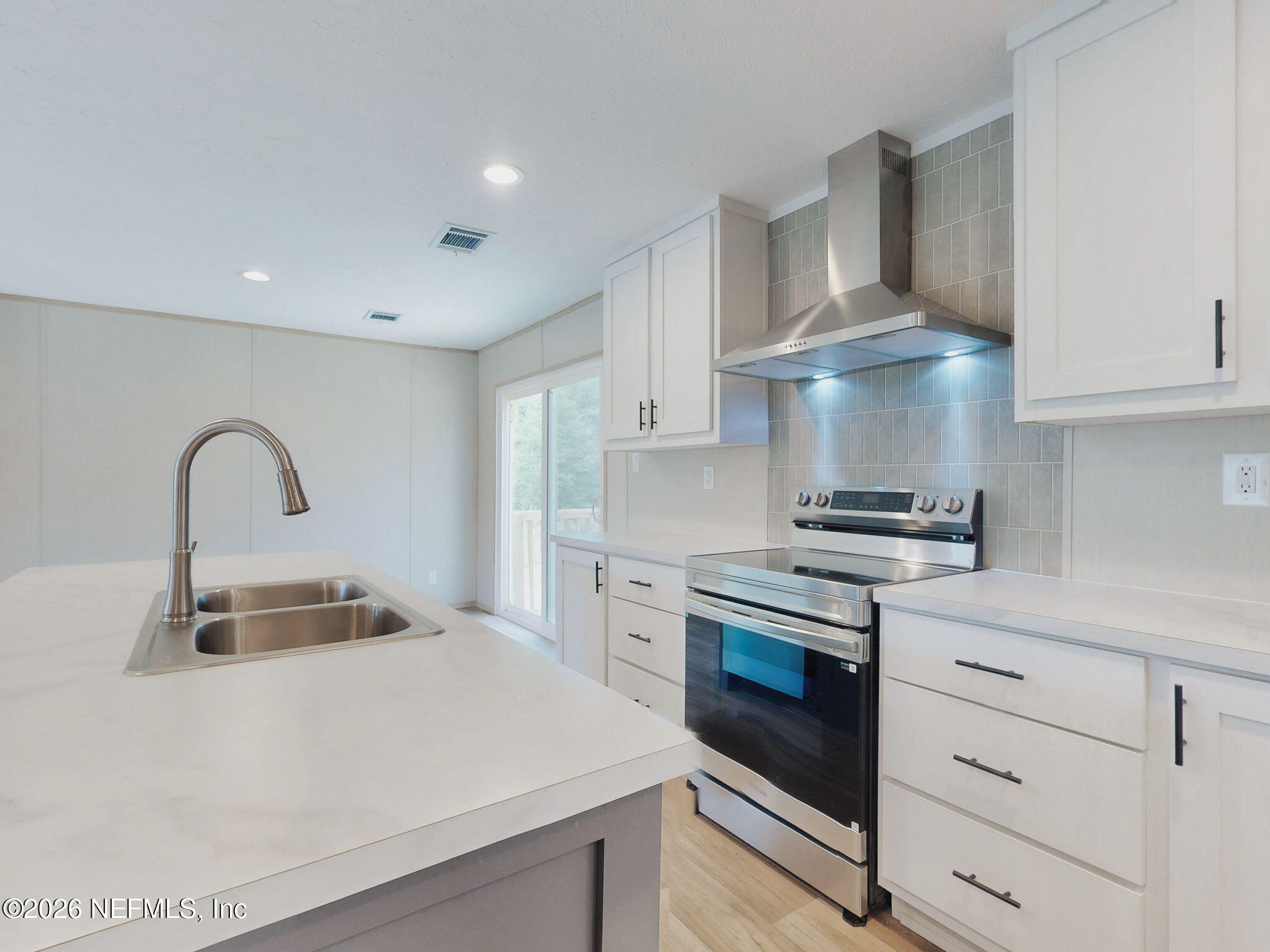 5784 County Road 214 Keystone Heights, FL 32656 - Photo 27 of 62 a kitchen with granite countertop a sink stainless steel appliances and cabinets