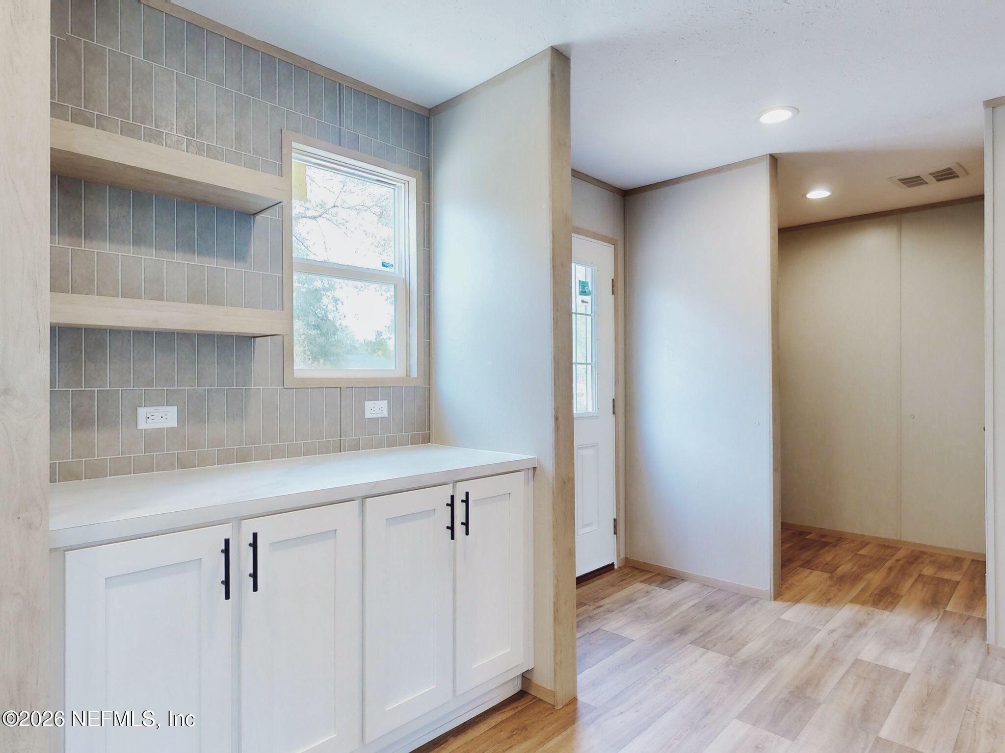 5784 County Road 214 Keystone Heights, FL 32656 - Photo 28 of 62 a view of an empty room with wooden floor and a window