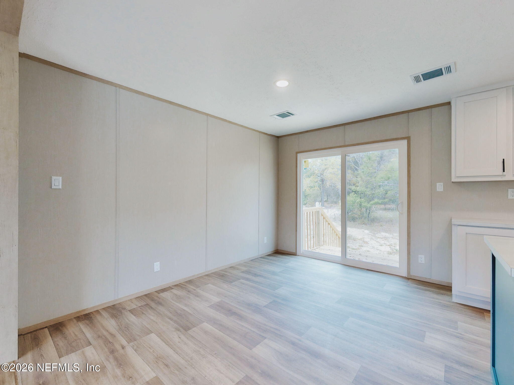 5784 County Road 214 Keystone Heights, FL 32656 - Photo 30 of 62 a view of an empty room with wooden floor and a window