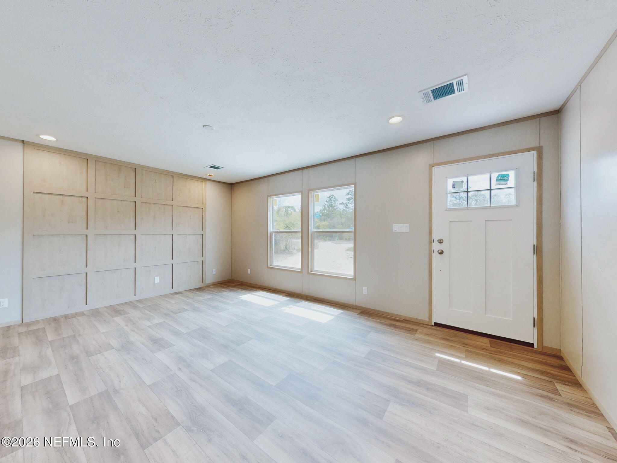 5784 County Road 214 Keystone Heights, FL 32656 - Photo 3 of 62 a view of an empty room with wooden floor and a window