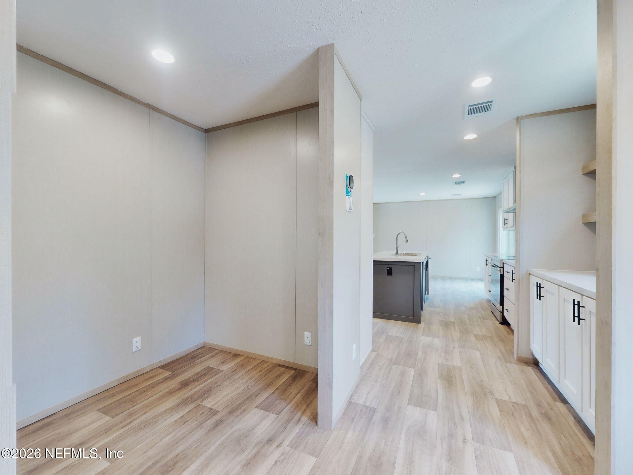 5784 County Road 214 Keystone Heights, FL 32656 - Photo 36 of 62 a view of a hallway with wooden floor and a bathroom