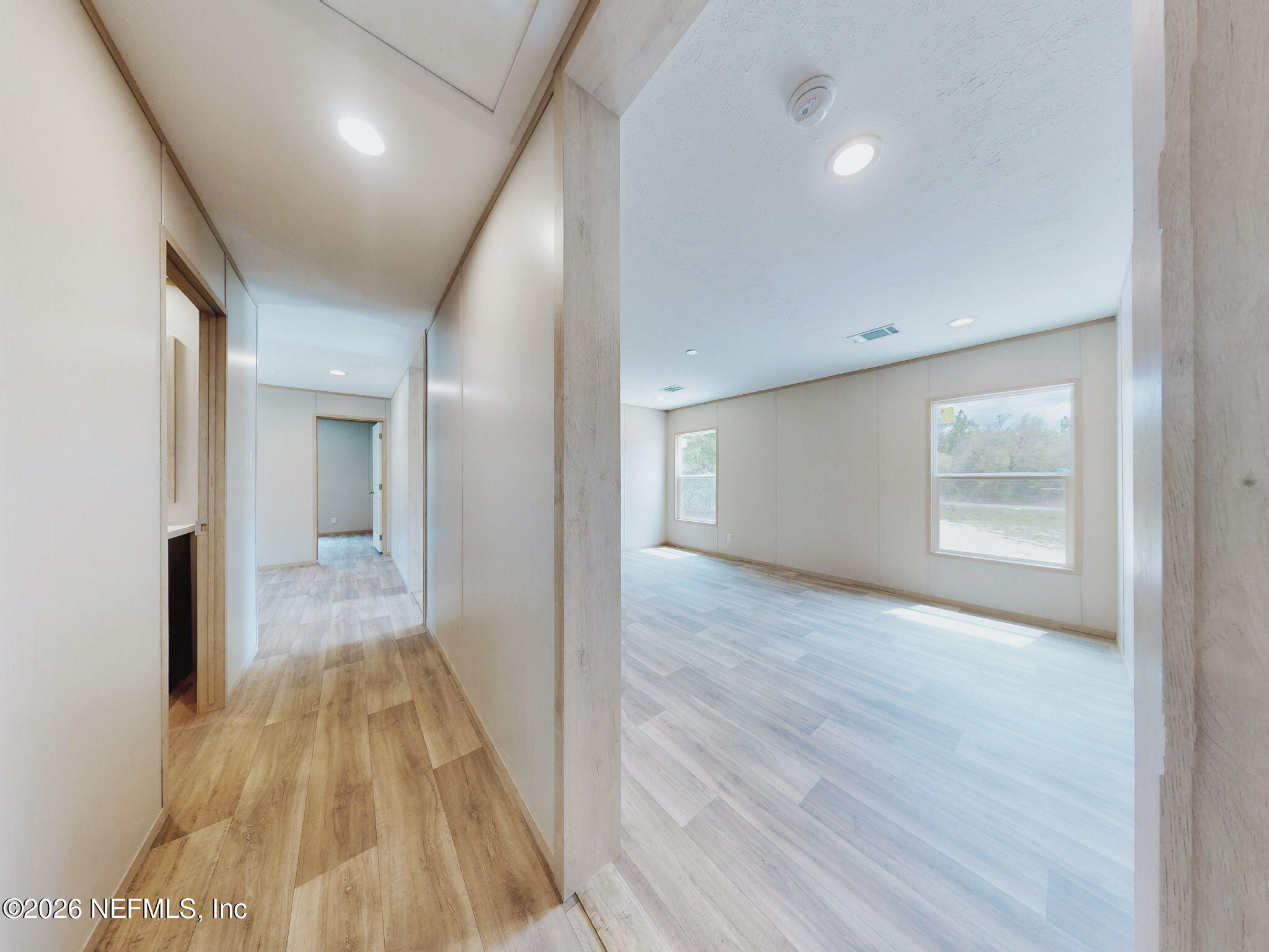 5784 County Road 214 Keystone Heights, FL 32656 - Photo 37 of 62 a view of a hallway with wooden floor and a bathroom