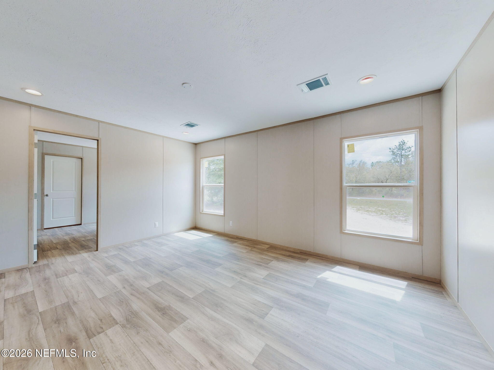 5784 County Road 214 Keystone Heights, FL 32656 - Photo 39 of 62 a view of an empty room with window and wooden floor