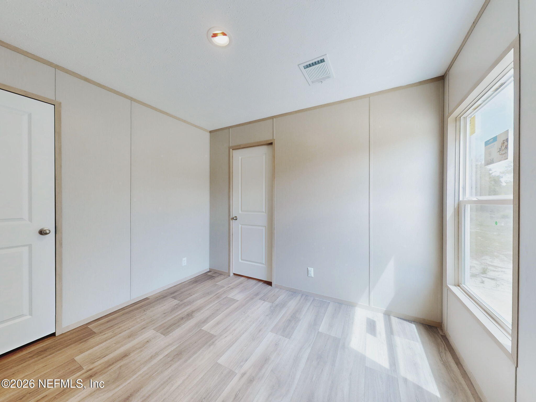 5784 County Road 214 Keystone Heights, FL 32656 - Photo 43 of 62 a view of empty room with wooden floor and fan