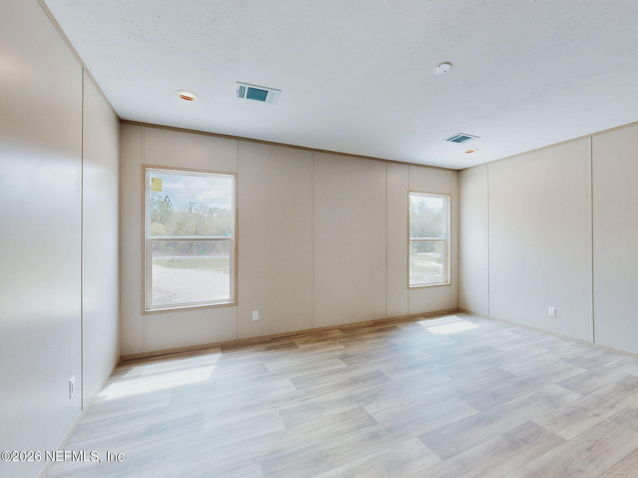 5784 County Road 214 Keystone Heights, FL 32656 - Photo 45 of 62 a view of an empty room with wooden floor and a window
