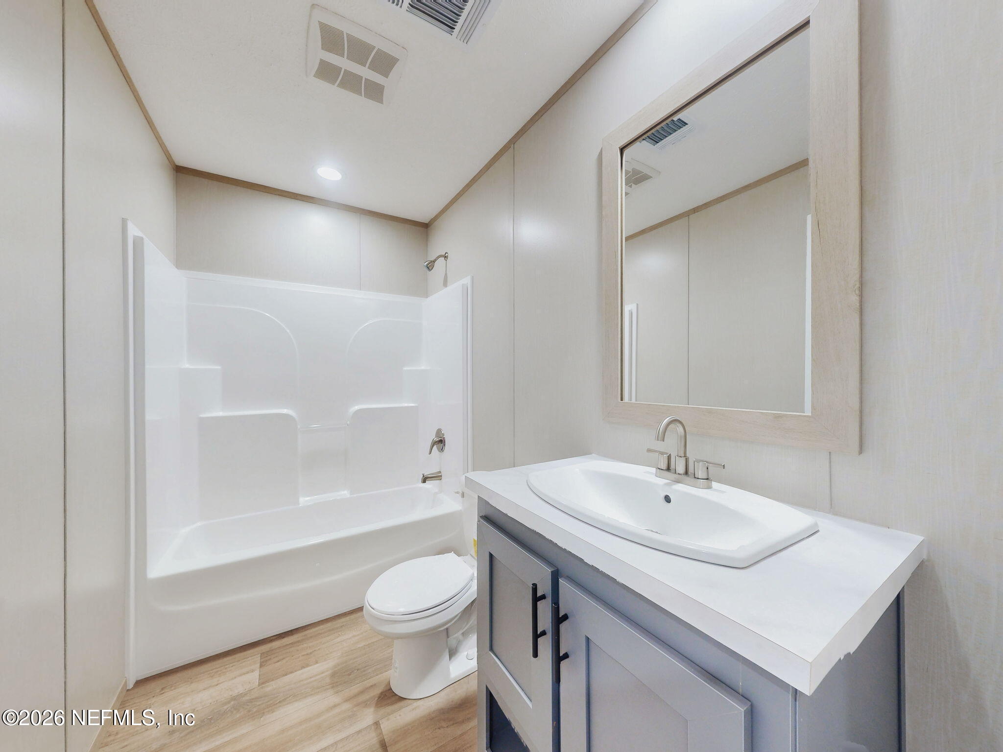 5784 County Road 214 Keystone Heights, FL 32656 - Photo 47 of 62 a bathroom with a sink toilet a mirror and shower