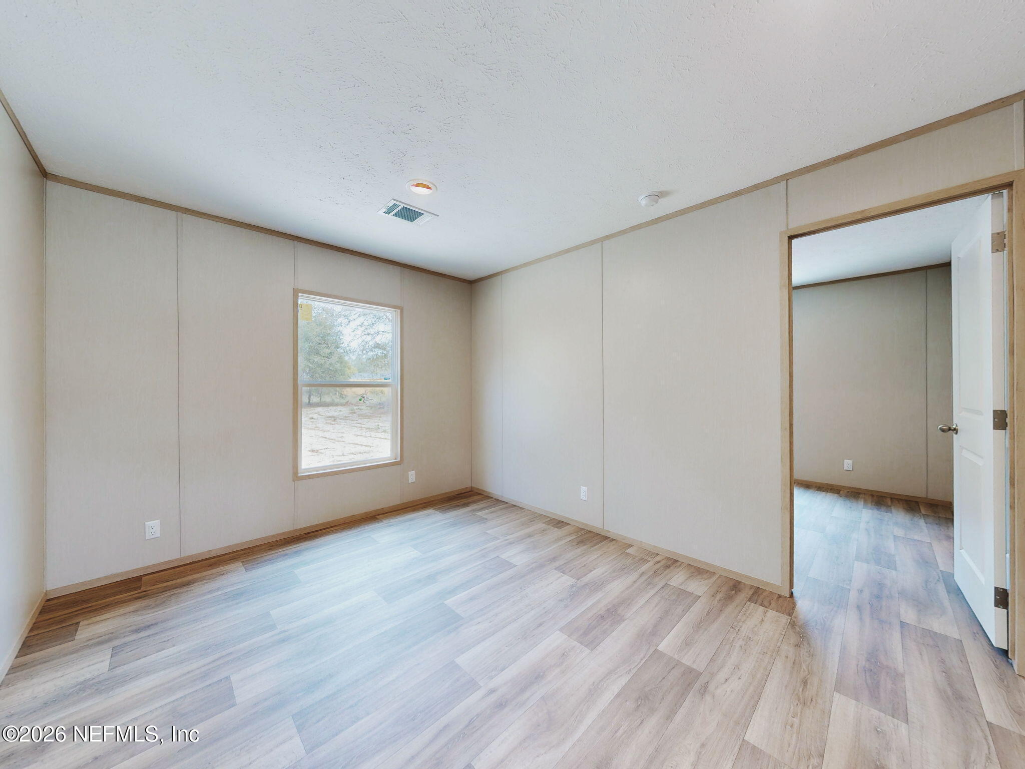 5784 County Road 214 Keystone Heights, FL 32656 - Photo 49 of 62 a view of an empty room with wooden floor and a window