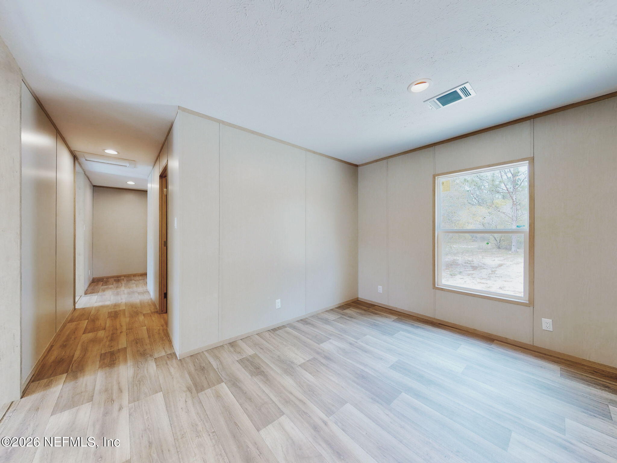 5784 County Road 214 Keystone Heights, FL 32656 - Photo 50 of 62 a view of an empty room with wooden floor and a window
