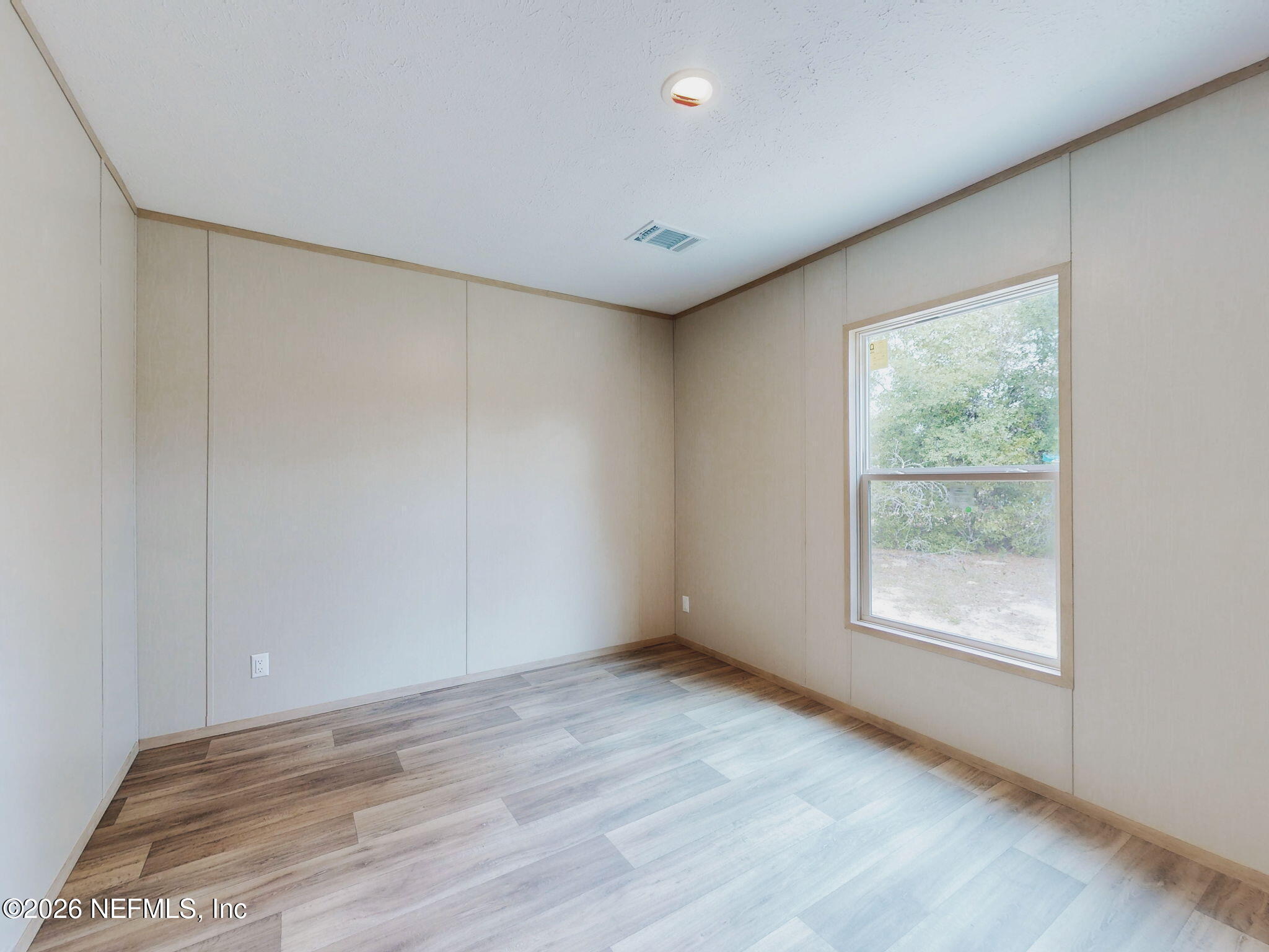 5784 County Road 214 Keystone Heights, FL 32656 - Photo 52 of 62 an empty room with wooden floor and windows