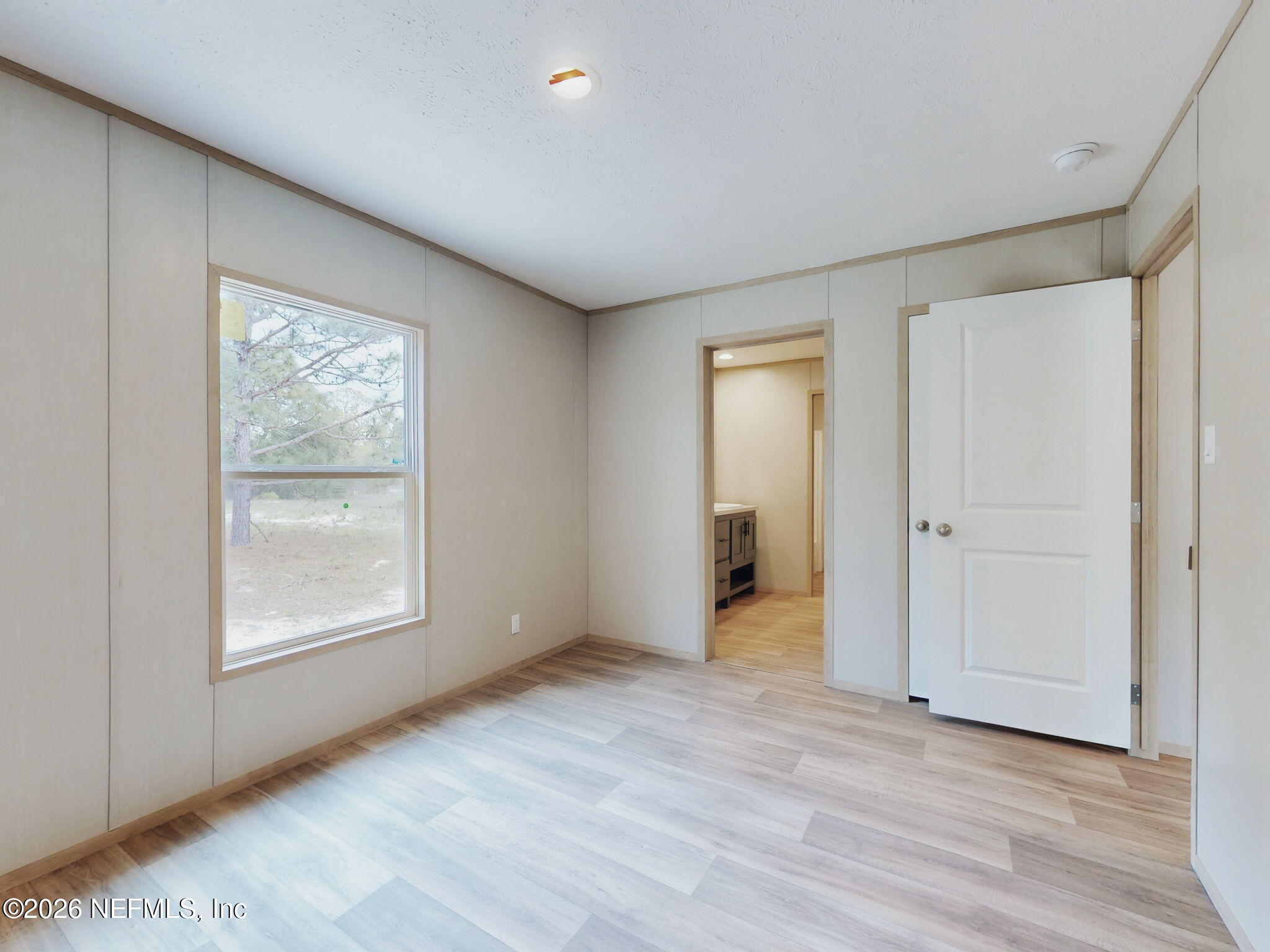 5784 County Road 214 Keystone Heights, FL 32656 - Photo 54 of 62 a view of an empty room with wooden floor and a window