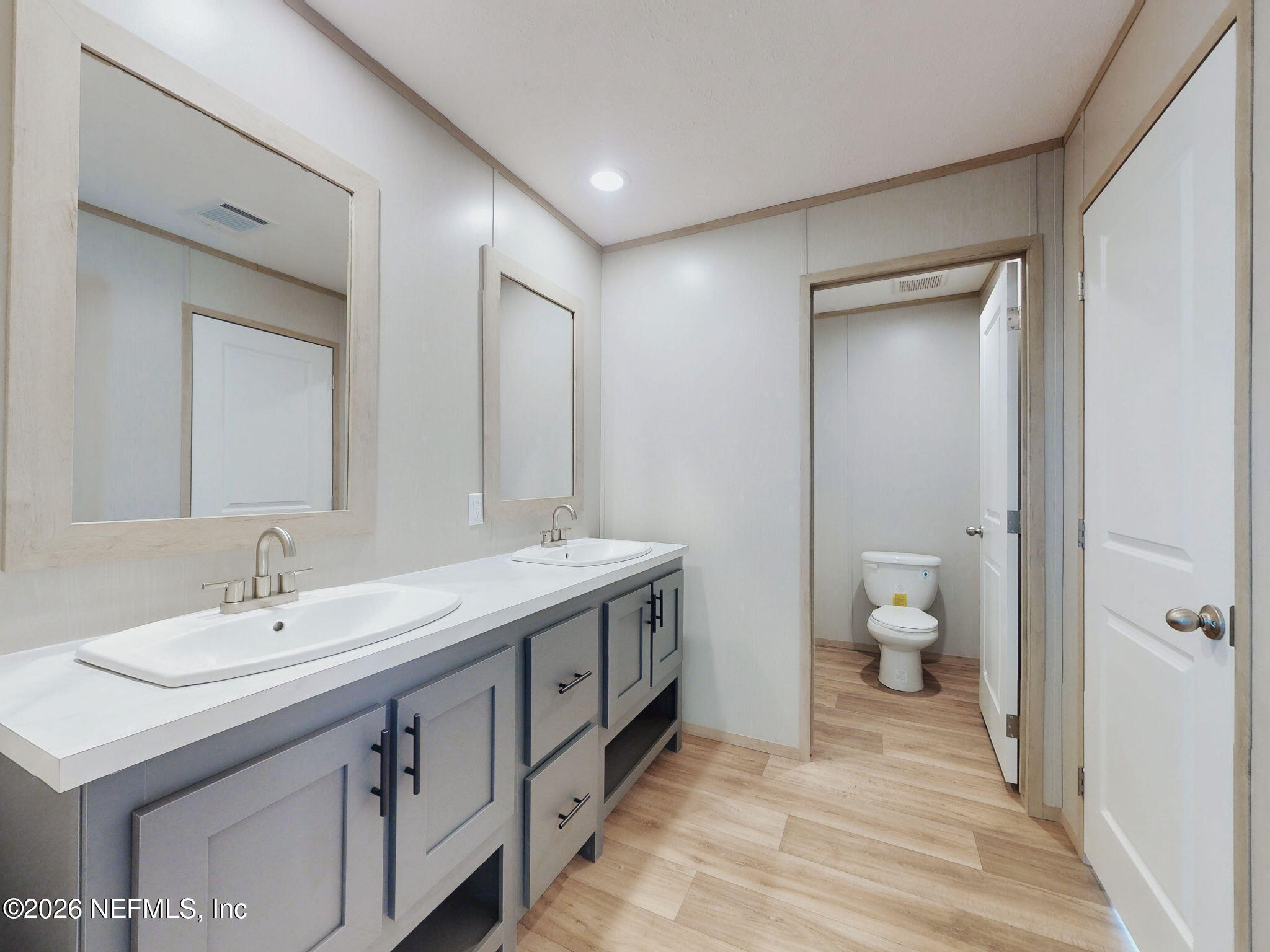5784 County Road 214 Keystone Heights, FL 32656 - Photo 55 of 62 a spacious bathroom with a double vanity sink mirror and toilet
