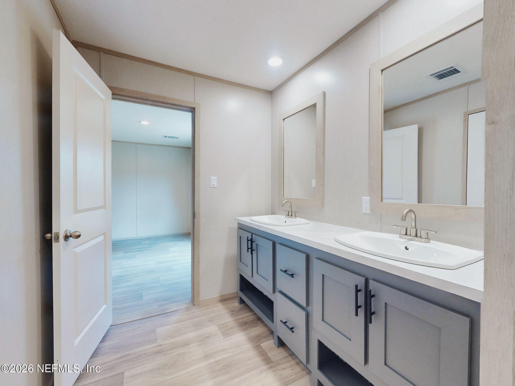 5784 County Road 214 Keystone Heights, FL 32656 - Photo 57 of 62 a spacious bathroom with a double vanity sink and a mirror