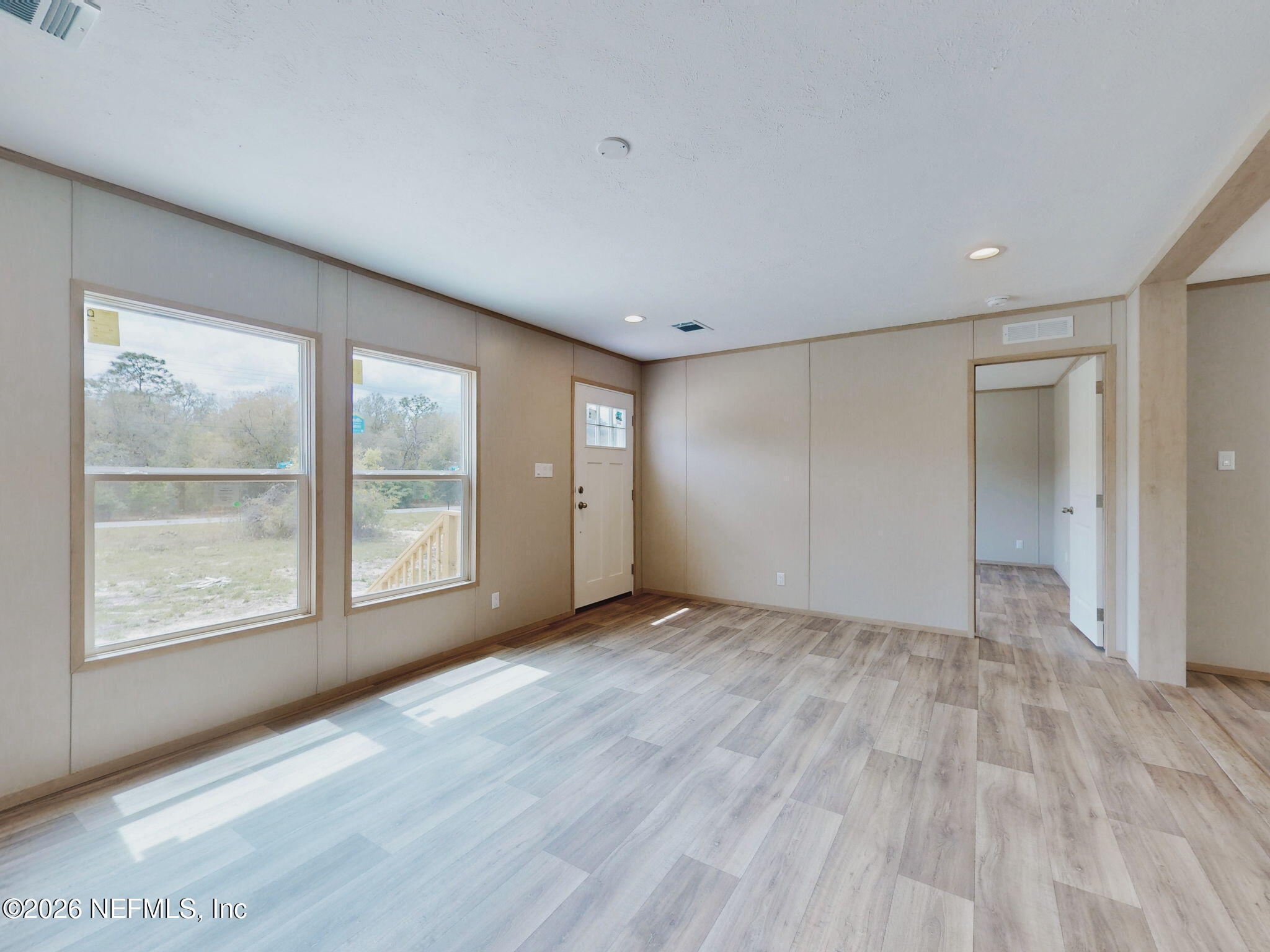 5784 County Road 214 Keystone Heights, FL 32656 - Photo 7 of 62 a view of an empty room with a window and wooden floor